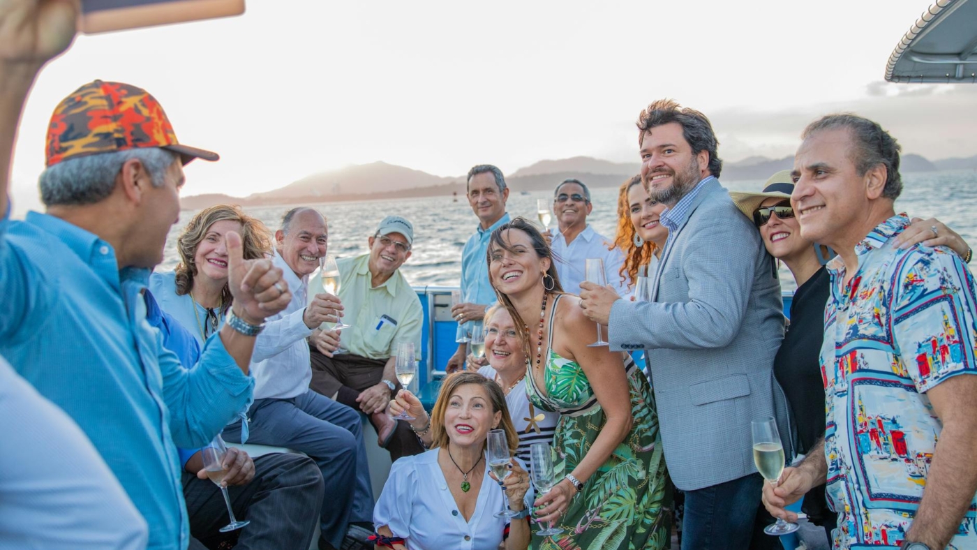 men and women taking group picture using smartphone