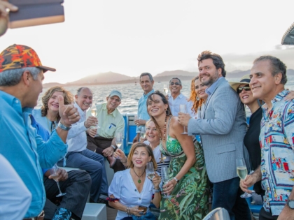 men and women taking group picture using smartphone