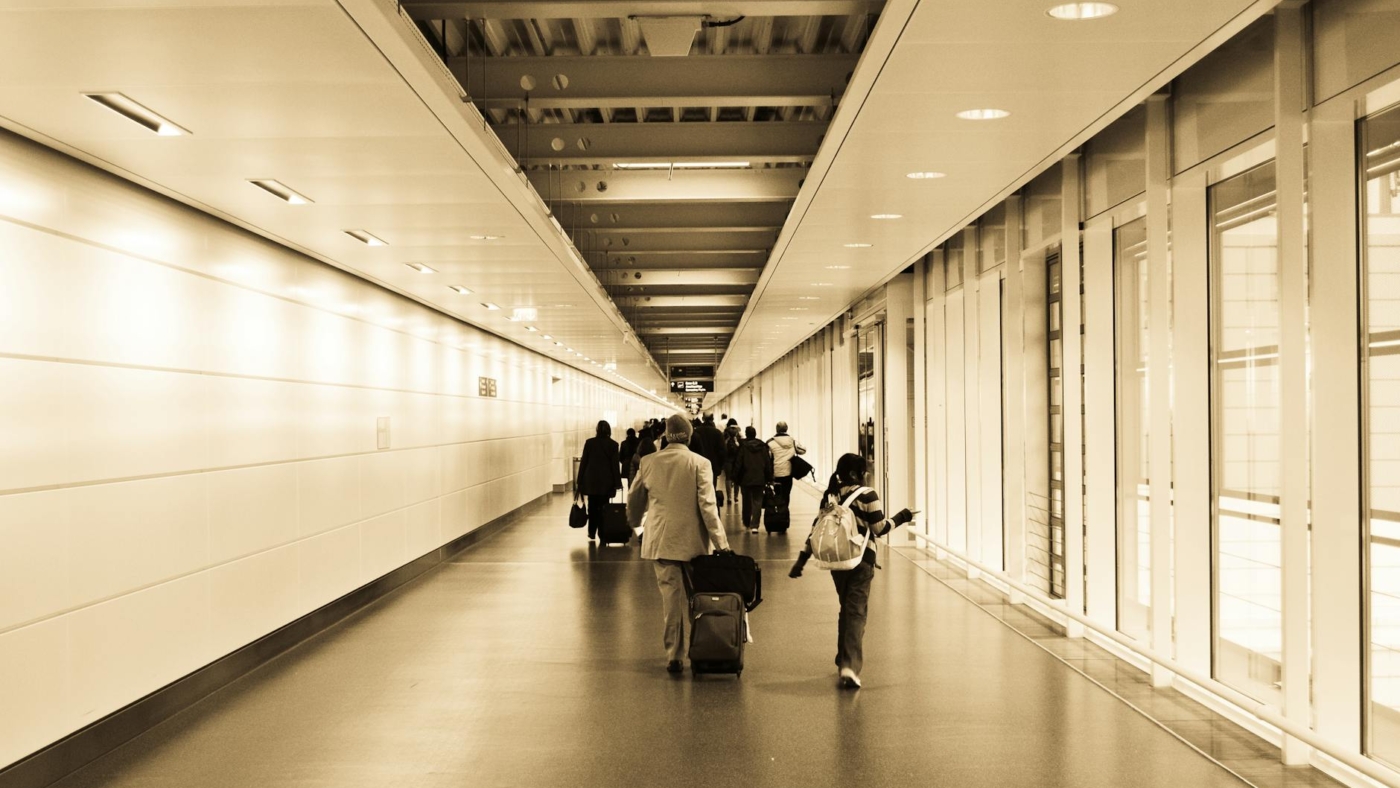 people walking in the hallway inside the building
