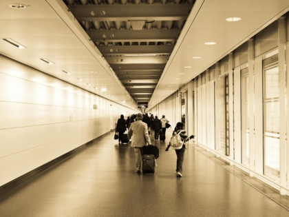 people walking in the hallway inside the building